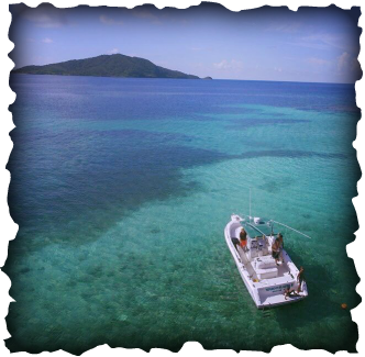 People snorkeling off the Wahoo Slayer boat on the reef in crystal clear waters out in the outer bay islands of Honduras